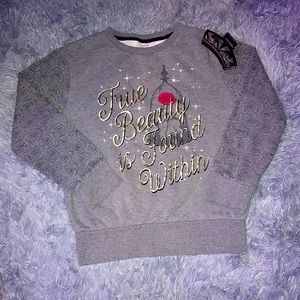 Got this at the Disney store in a large. Gray sweatshirt with elastic bottom.